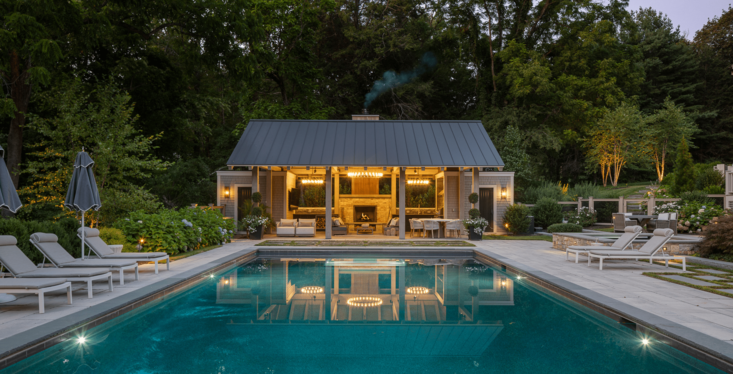 Suburban Transitional Pool House at dusk